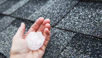 Hand Holding a Large Hailstone