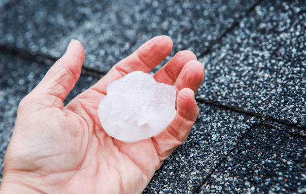 Hand Holding a Large Hailstone